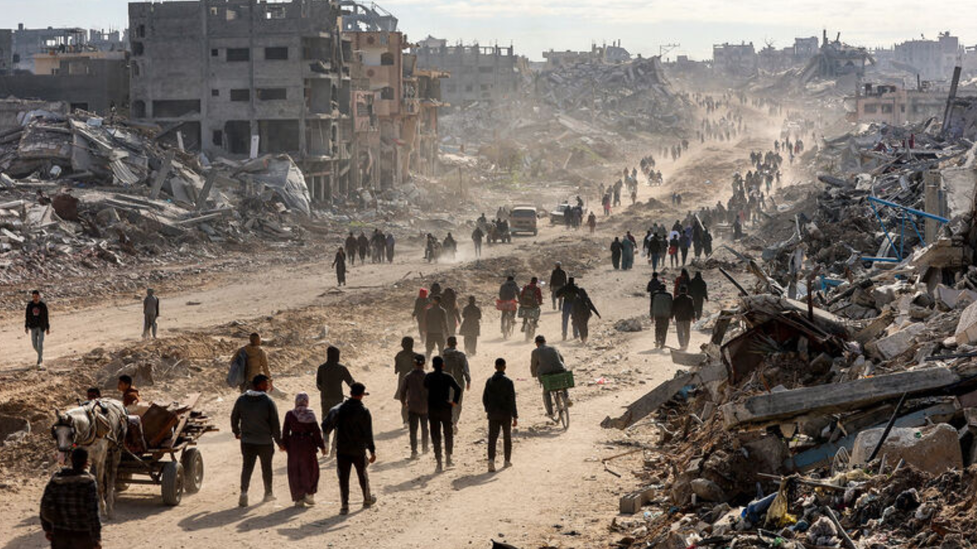 People walk past rubble in Jabalia in the northern Gaza Strip on January 20 2025.
